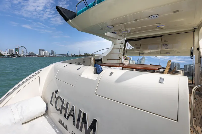 Slide: The Image of 2007 Azimut Fly 62 yacht in Miami, featuring spacious deck and city skyline view. - 7