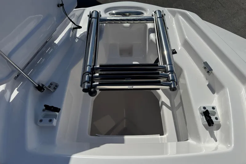 Slide: The Image of 2025 Yamaha Boats AR250 bow storage compartment with stainless steel ladder. - 10
