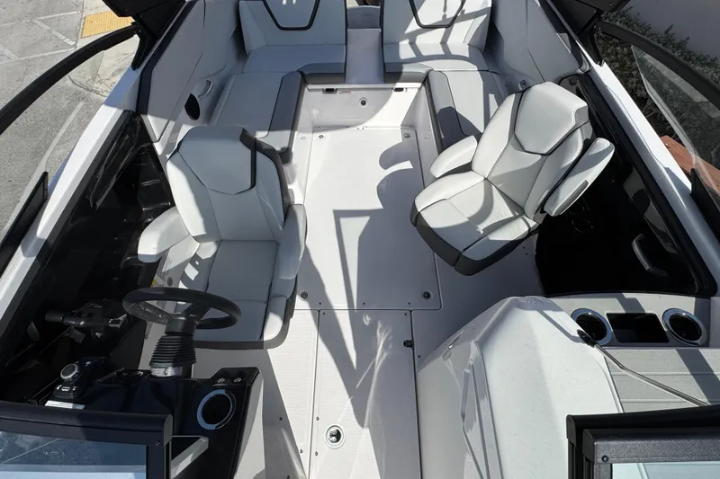 Slide: The Image of 2025 Yamaha Boats AR250 interior with sleek seating and modern dashboard design. - 12