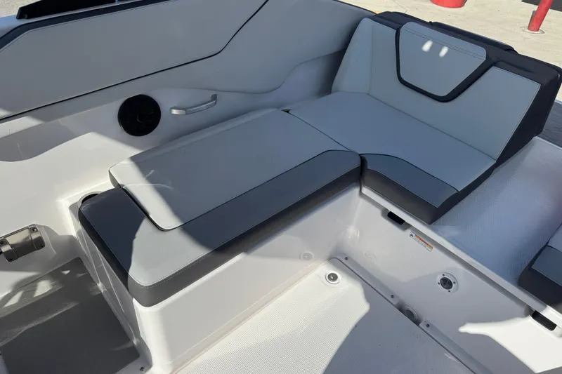 Slide: The Image of 2025 Yamaha AR250 boat interior seating with gray cushions and sleek design. - 18