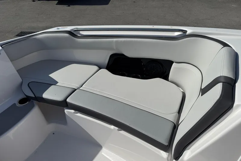 Slide: The Image of 2025 Yamaha Boats AR250 interior seating with gray and white upholstery. - 7