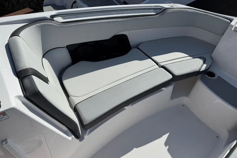 Slide: The Image of 2025 Yamaha Boats AR250 interior seating with sleek, modern design and comfortable cushions. - 8