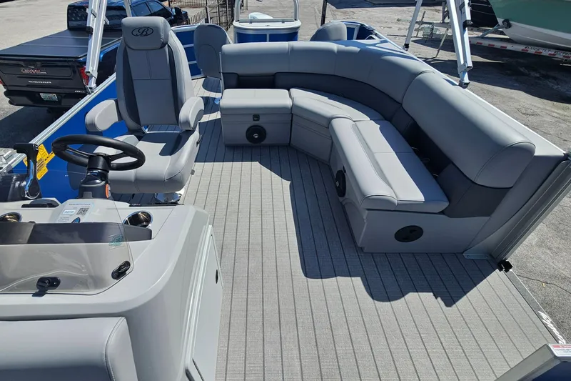 Slide: The Image of 2026 Bentley Pontoons 203 Fish-N-Cruise interior with gray seating and steering console. - 10