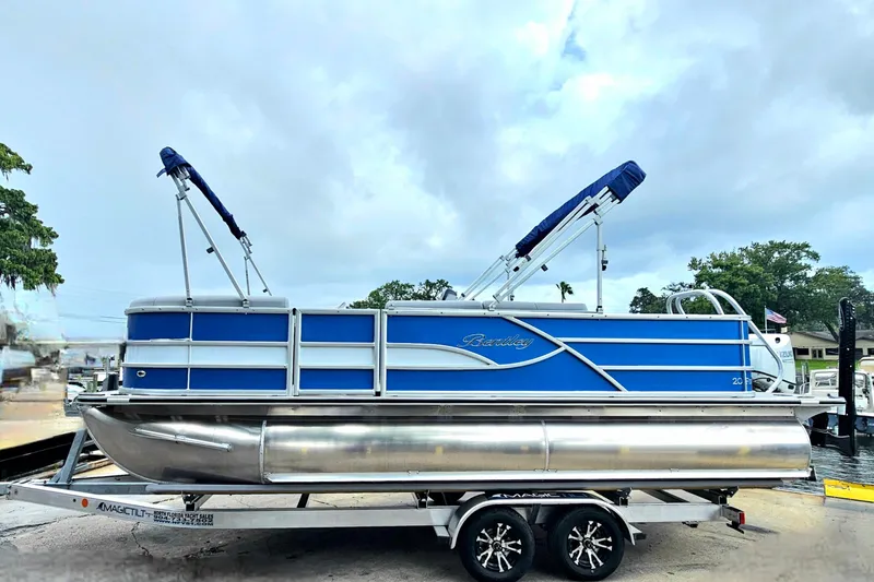 Slide: The Image of 2026 Bentley Pontoons 203 Fish-N-Cruise on trailer, blue exterior, parked outdoors. - 2