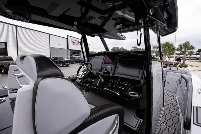 Slide: The Image of 2024 Sunsation 32 CCX boat interior with modern dashboard and seating. - 11