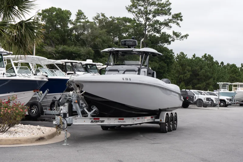 Slide: The Image of 2024 Sunsation 32 CCX boat on trailer in marina parking lot. - 3