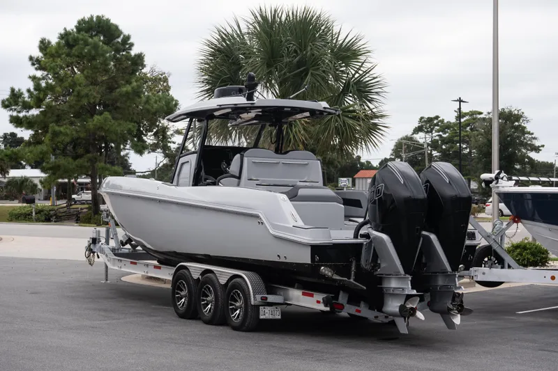 Slide: The Image of 2024 Sunsation 32 CCX boat on trailer with dual engines, parked outdoors. - 5