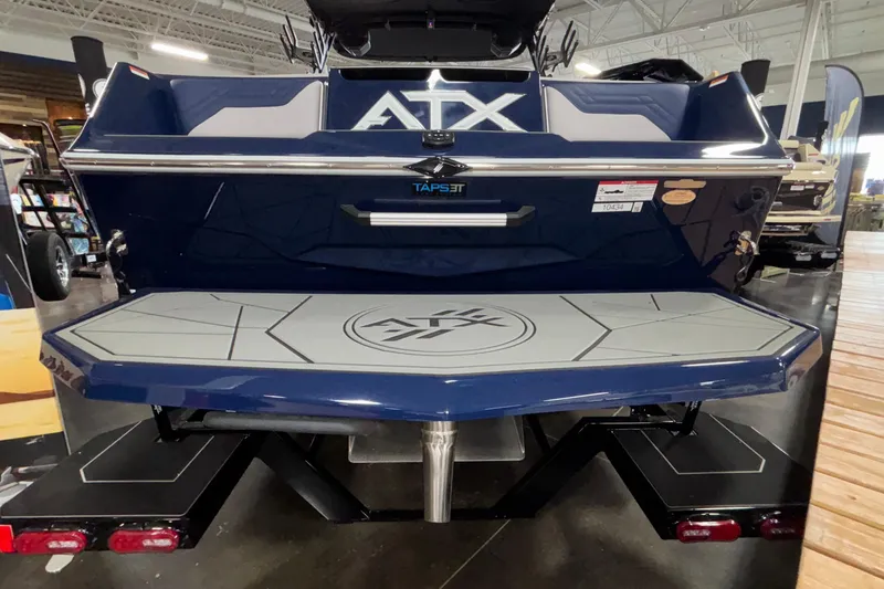 Slide: The Image of 2026 ATX Surf Boats 24 Type-S, rear view in showroom, showcasing swim platform. - 28