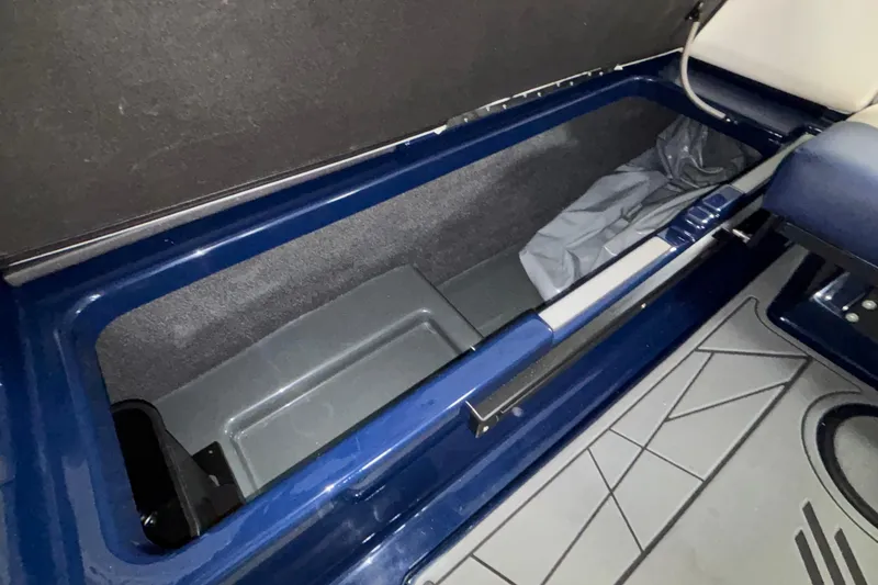 Slide: The Image of 2026 ATX Surf Boats 24 Type-S storage compartment with blue interior and gray flooring. - 31