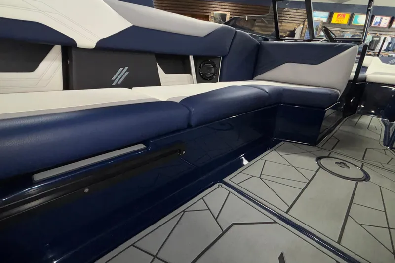 Slide: The Image of 2026 ATX Surf Boats 24 Type-S interior with blue and white seating and geometric flooring. - 36