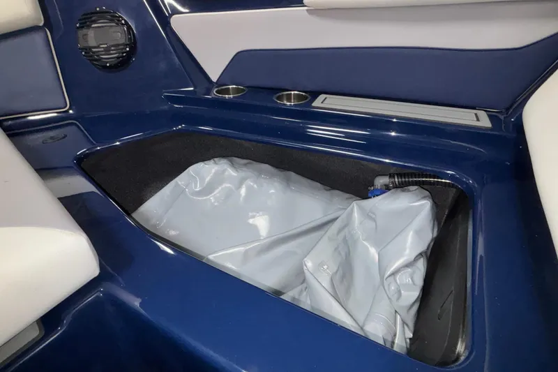 Slide: The Image of 2026 ATX Surf Boats 24 Type-S interior storage compartment with blue and white seating. - 40