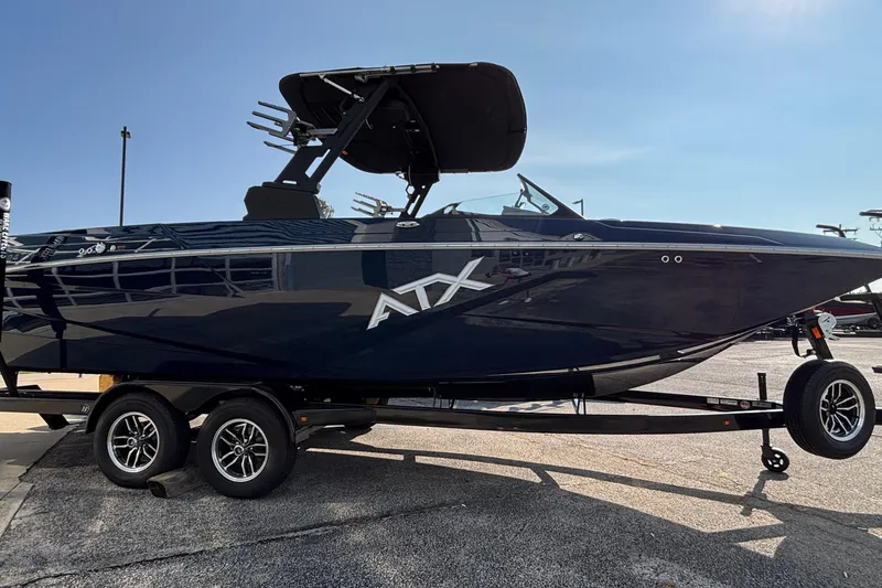 Slide: The Image of 2026 ATX Surf Boats 24 Type-S on trailer, sleek design, black exterior, sunny day. - 6