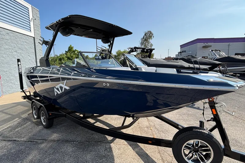 Slide: The Image of 2026 ATX Surf Boats 24 Type-S in a showroom, sleek design, on a trailer. - 7