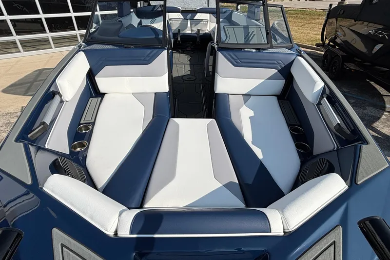 Slide: The Image of 2026 ATX Surf Boats 24 Type-S interior with blue and white seating, cup holders, and speakers. - 8