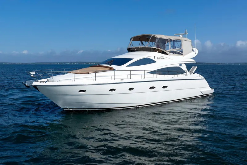 Slide: The Image of 2005 Aicon Yachts 56 Flybridge cruising on open water under clear blue skies. - 10
