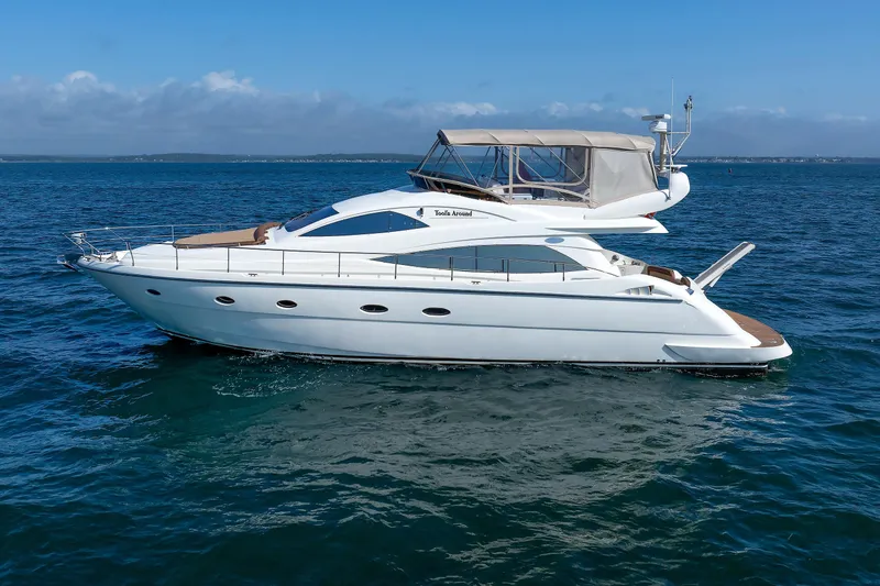 Slide: The Image of 2005 Aicon Yachts 56 Flybridge cruising on open water under clear skies. - 12