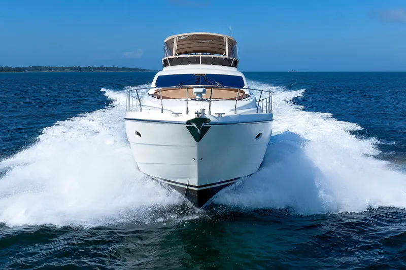 Slide: The Image of Aicon Yachts 56 Flybridge 2005 cruising on open sea, creating dynamic waves. - 13