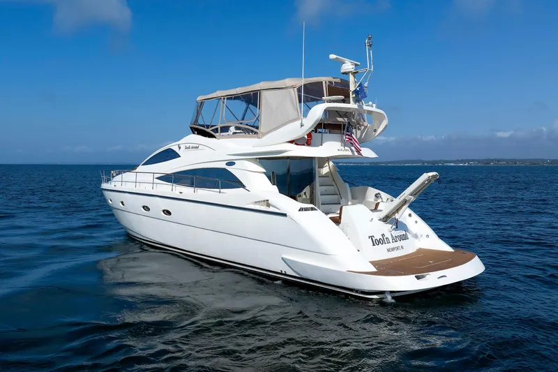 Slide: The Image of Aicon Yachts 56 Flybridge 2005 cruising on open water under clear blue skies. - 14