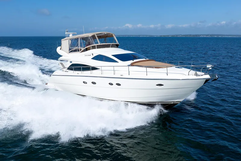 Slide: The Image of Aicon Yachts 56 Flybridge 2005 cruising on open sea, showcasing sleek design and luxury. - 15