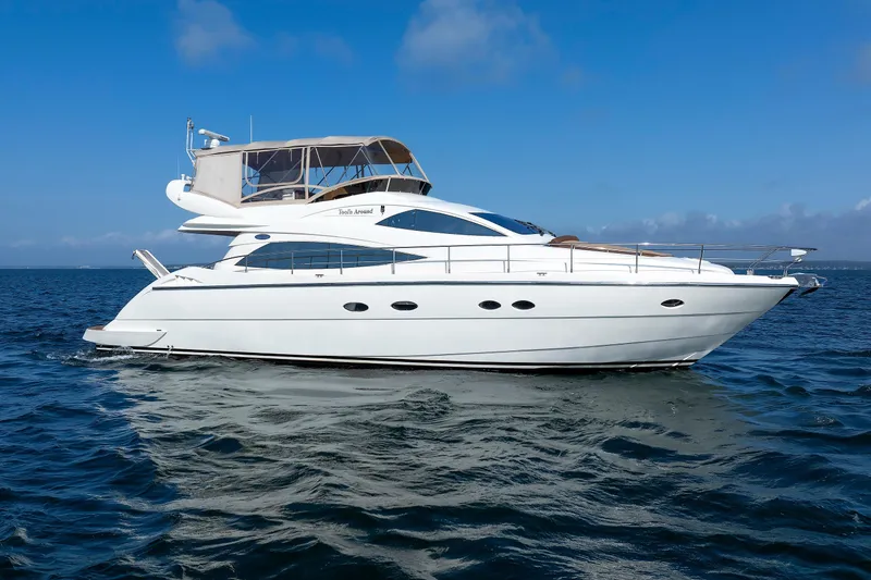 Slide: The Image of Aicon Yachts 56 Flybridge 2005 cruising on open water under clear blue skies. - 16