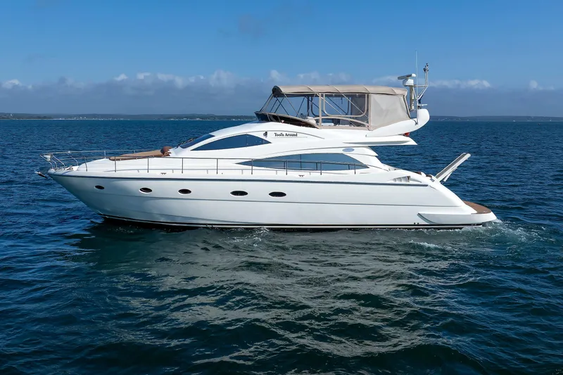 Slide: The Image of 2005 Aicon Yachts 56 Flybridge cruising on open water under clear blue skies. - 17