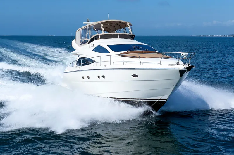 Slide: The Image of Aicon Yachts 56 Flybridge 2005 cruising on open water, showcasing sleek design and speed. - 18