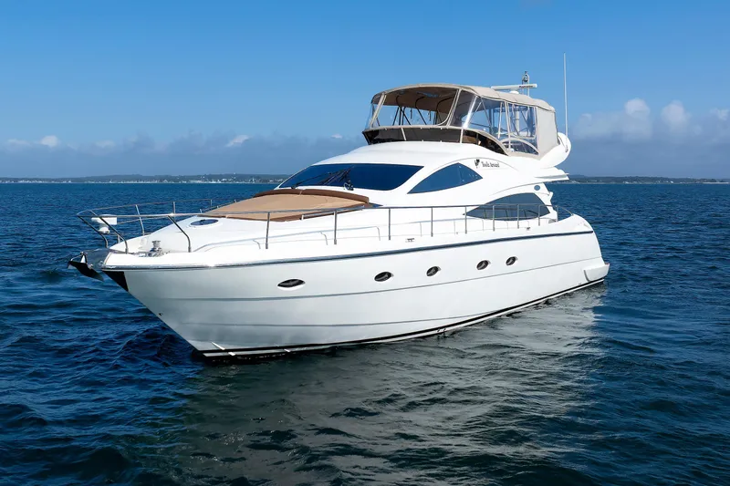 Slide: The Image of Aicon Yachts 56 Flybridge 2005 cruising on open water under clear blue skies. - 19