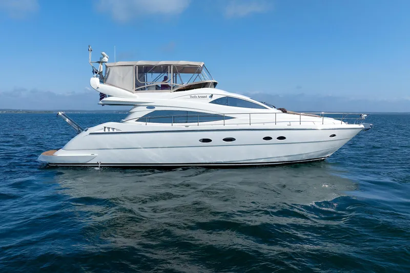 Slide: The Image of Aicon Yachts 56 Flybridge 2005 cruising on open water under clear skies. - 2