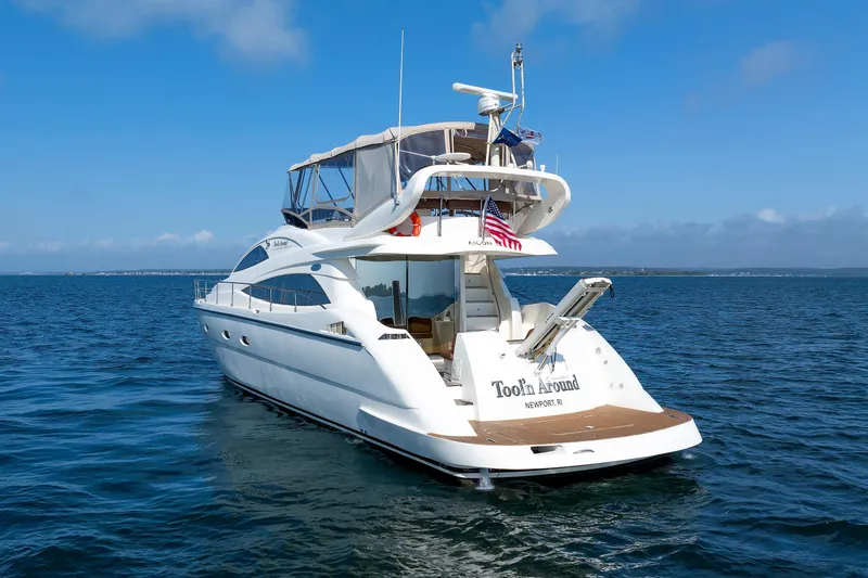 Slide: The Image of Aicon Yachts 56 Flybridge 2005 on open water, rear view with American flag. - 21