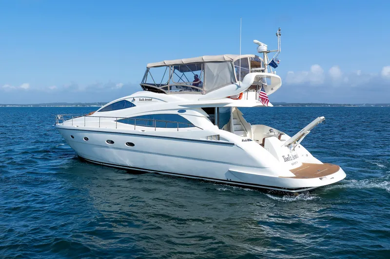 Slide: The Image of Aicon Yachts 56 Flybridge 2005 cruising on open water under clear skies. - 22