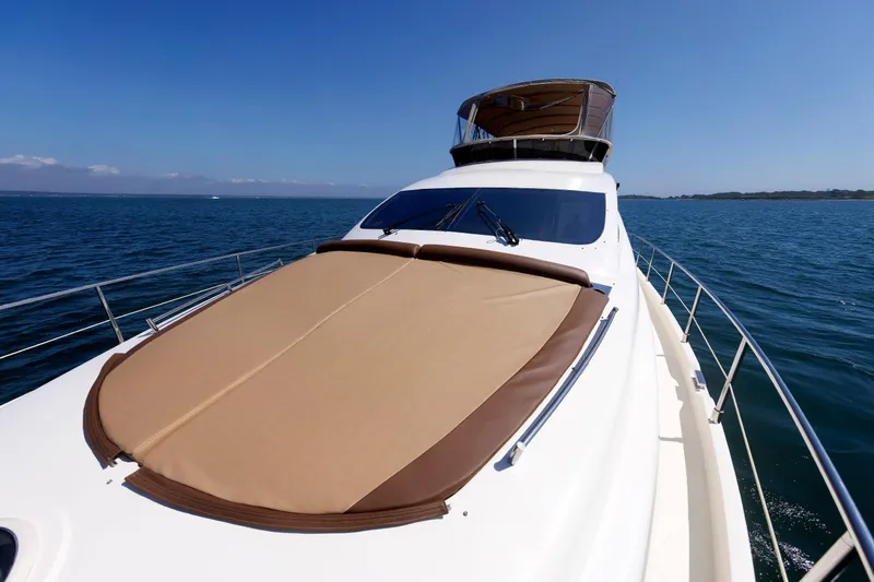 Slide: The Image of Aicon Yachts 56 Flybridge 2005 cruising on open water under clear blue skies. - 24