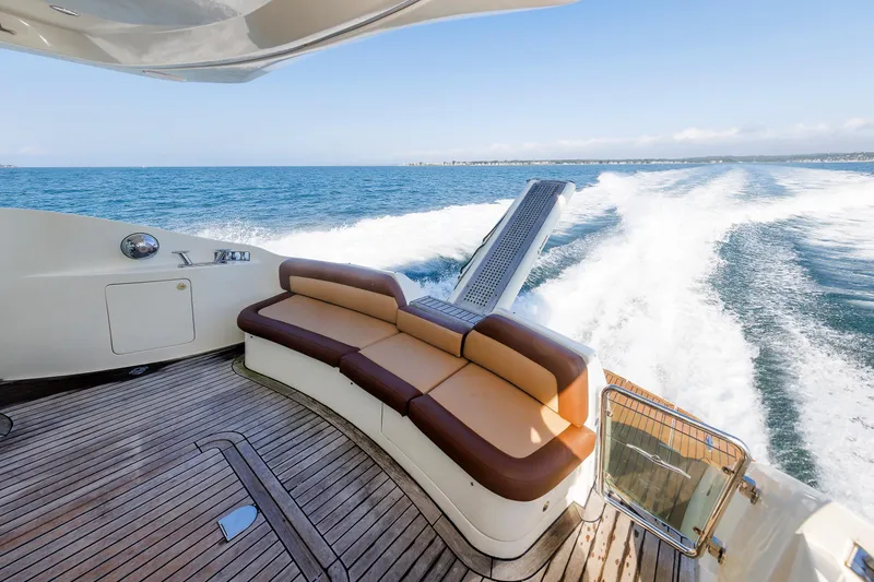Slide: The Image of Aicon Yachts 56 Flybridge 2005, luxury yacht deck with seating, cruising on open sea. - 26
