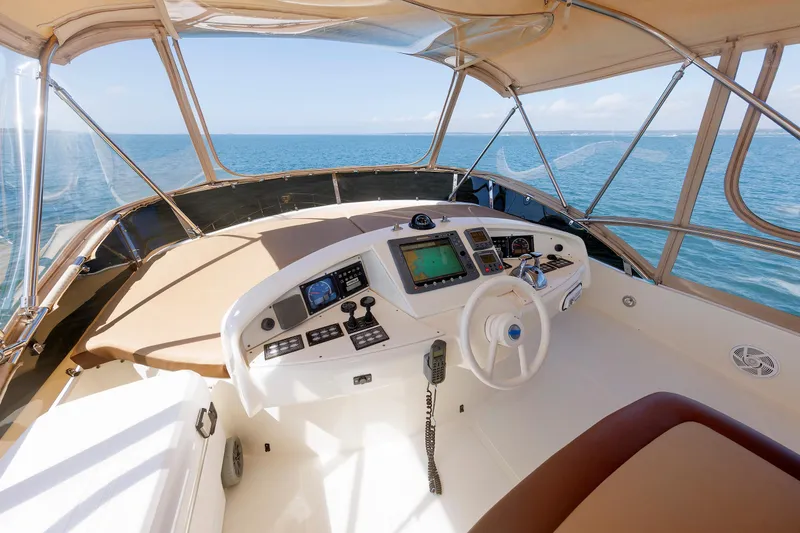 Slide: The Image of Flybridge helm of 2005 Aicon Yachts 56, featuring navigation controls and ocean view. - 29