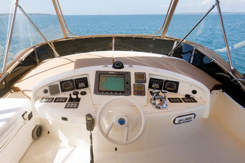 Slide: The Image of Flybridge helm of 2005 Aicon Yachts 56, featuring navigation controls and ocean view. - 31