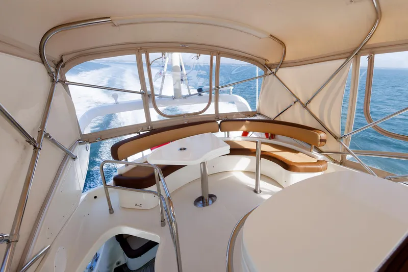 Slide: The Image of Flybridge view of 2005 Aicon Yachts 56, featuring elegant seating and ocean backdrop. - 33