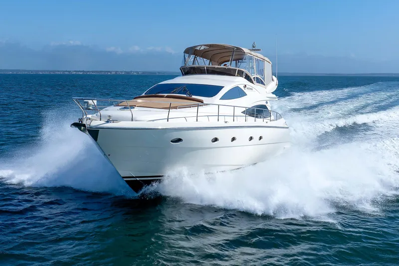 Slide: The Image of Aicon Yachts 56 Flybridge 2005 cruising on open sea, creating dynamic waves. - 4