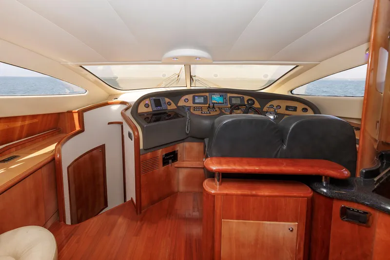 Slide: The Image of Luxurious interior of 2005 Aicon Yachts 56 Flybridge, featuring elegant wood finishes and modern controls. - 42