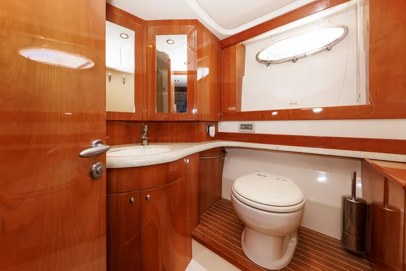 Slide: The Image of Luxurious bathroom in 2005 Aicon Yachts 56 Flybridge, featuring wood accents and modern fixtures. - 56