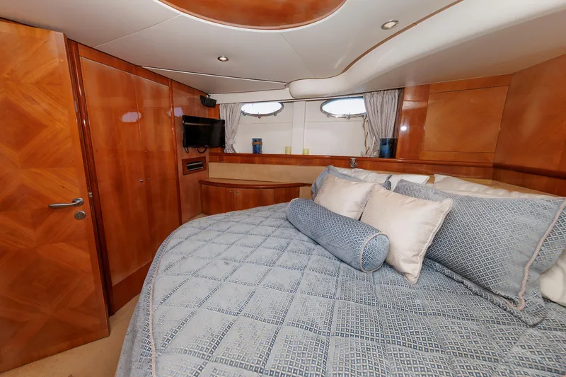 Slide: The Image of Luxurious bedroom interior of 2005 Aicon Yachts 56 Flybridge with elegant wood finishes. - 58