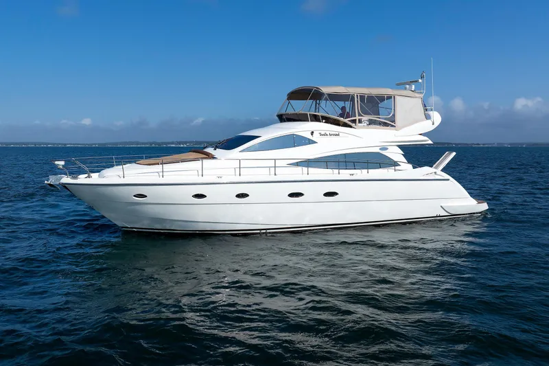 Slide: The Image of Aicon Yachts 56 Flybridge 2005 cruising on open water under clear blue skies. - 6