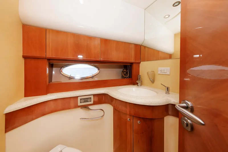 Slide: The Image of Luxurious bathroom in 2005 Aicon Yachts 56 Flybridge, featuring elegant wood cabinetry and modern fixtures. - 64