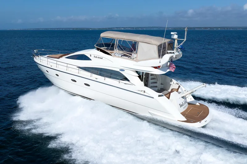 Slide: The Image of Aicon Yachts 56 Flybridge 2005 cruising on open sea, showcasing sleek design and luxury. - 7