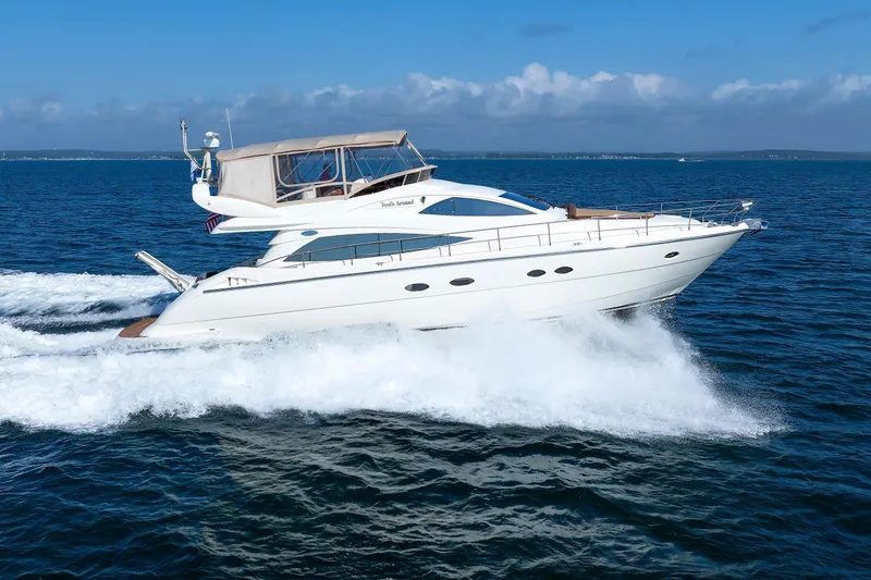 Slide: The Image of Aicon Yachts 56 Flybridge 2005 cruising on open sea under clear blue sky. - 9