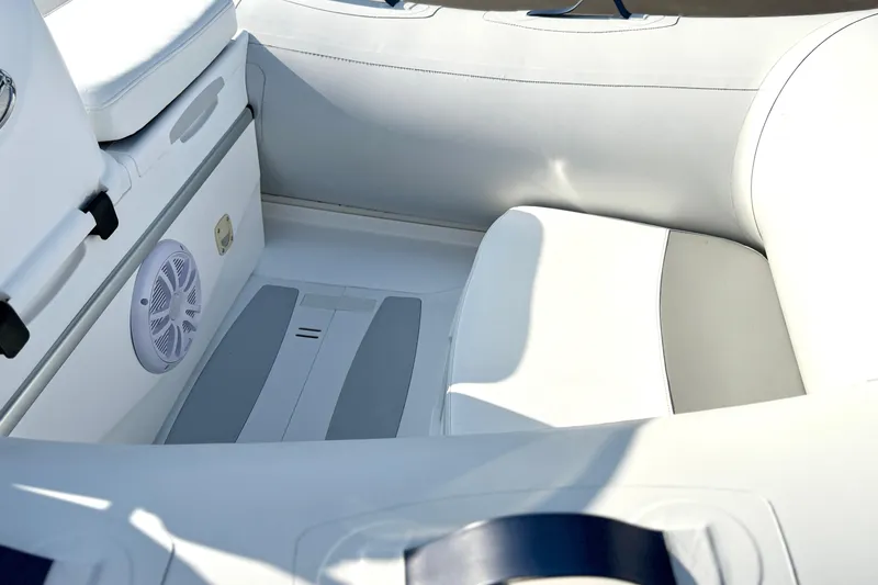 Slide: The Image of Interior of 2015 Walker Bay Genisis 310 boat, featuring white seating and speaker. - 10