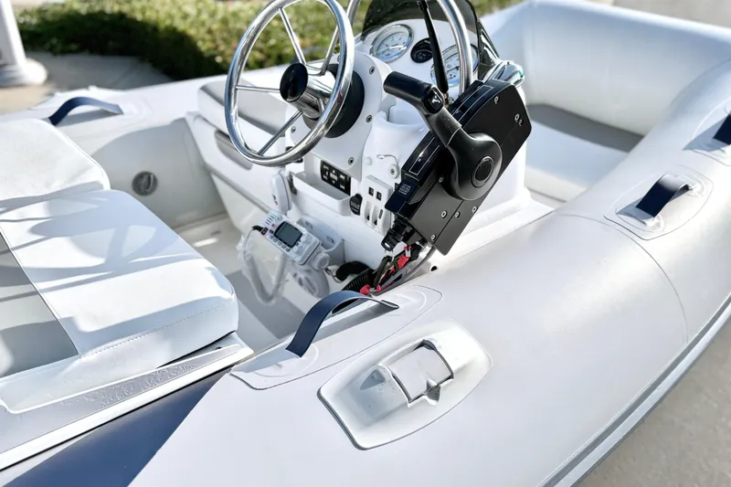 Slide: The Image of 2015 Walker Bay Genisis 310 boat interior with steering wheel and controls. - 16