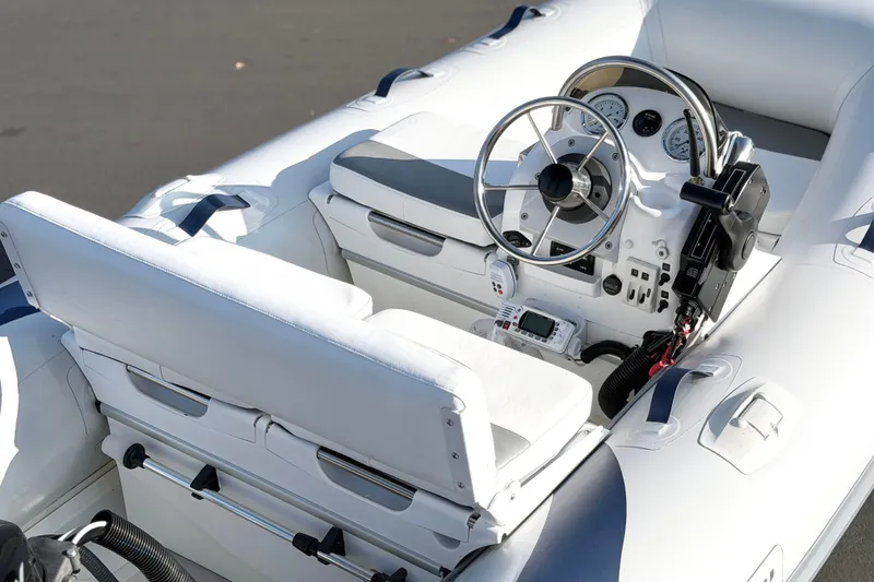 Slide: The Image of 2015 Walker Bay Genisis 310 boat interior with steering wheel and control panel. - 21
