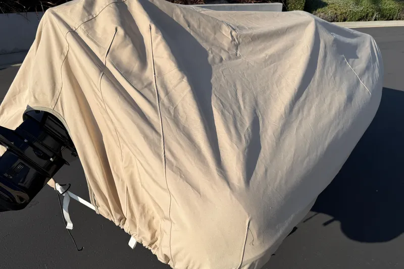 Slide: The Image of Covered 2015 Walker Bay Genisis 310 boat with visible outboard motor. - 5