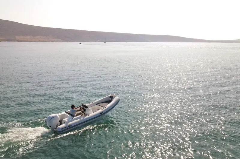 Slide: The Image of 2026 Northstar AXIS 5.3 boat cruising on a sunlit, tranquil sea. - 3