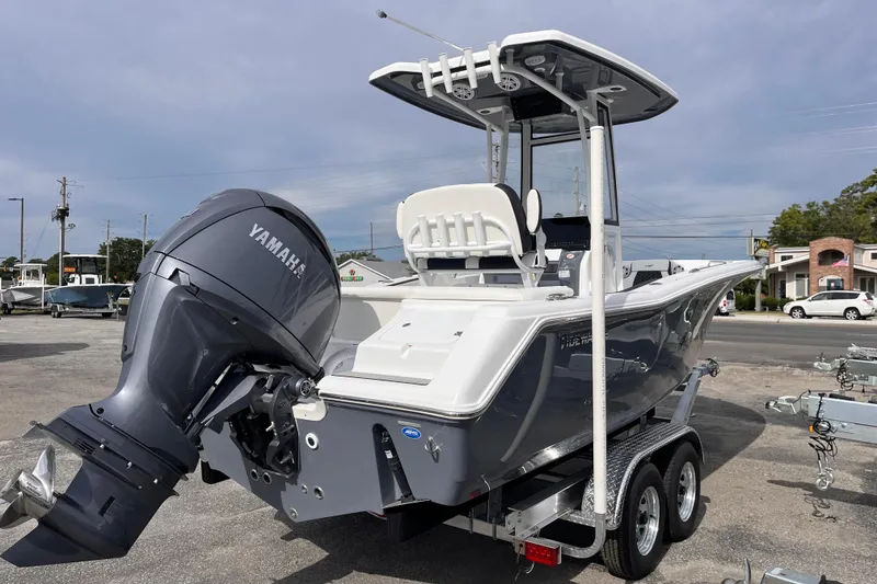 Slide: The Image of 2026 Tidewater 220 LXF boat with Yamaha engine on a trailer, parked outdoors. - 4