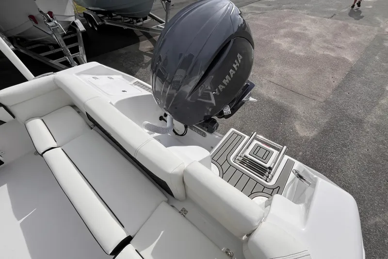 Slide: The Image of 2026 Tidewater 220 LXF boat with Yamaha engine, featuring sleek white seating and deck. - 5